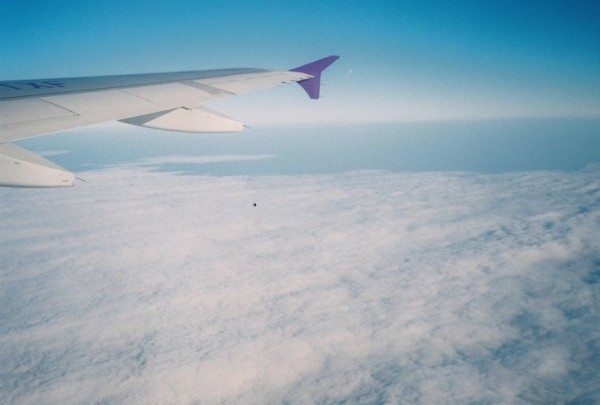 staring out the plane window the cars becoming smaller and smaller as you climb into the sky